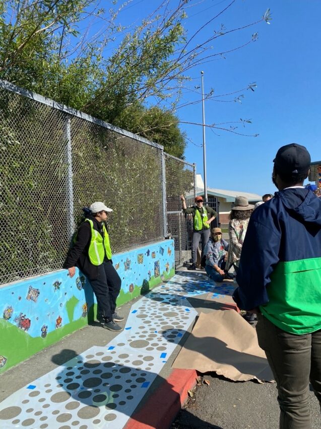 People looking at sidewalk painting