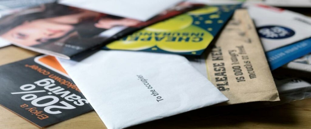 A cluttered pile of junk mail
