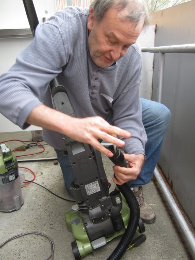 A man working on a vacuum cleaner
