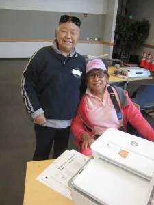 Man and lady behind printer on desk
