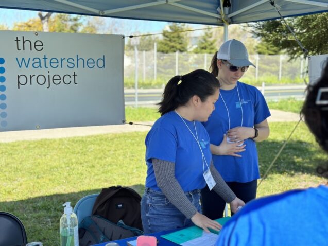 Two volunteers in The Watershed Project booth