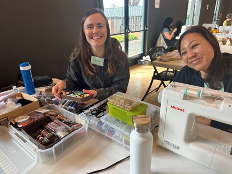 Residents at the repair workshop fixing their sewing machines.