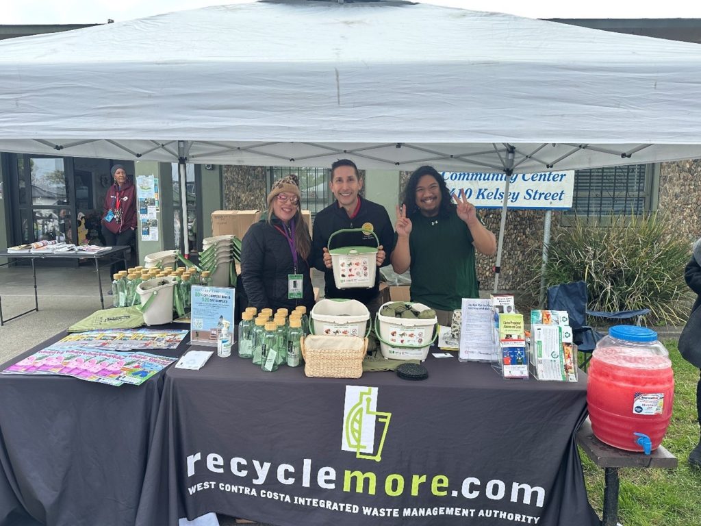 RecycleMore staff Webster Nguyen and Lisa Borreani, with WCCIWMA Board Chair Cesar Zepeda, at the RecycleMore booth for the North Richmond 2025 Earth Day Event. 